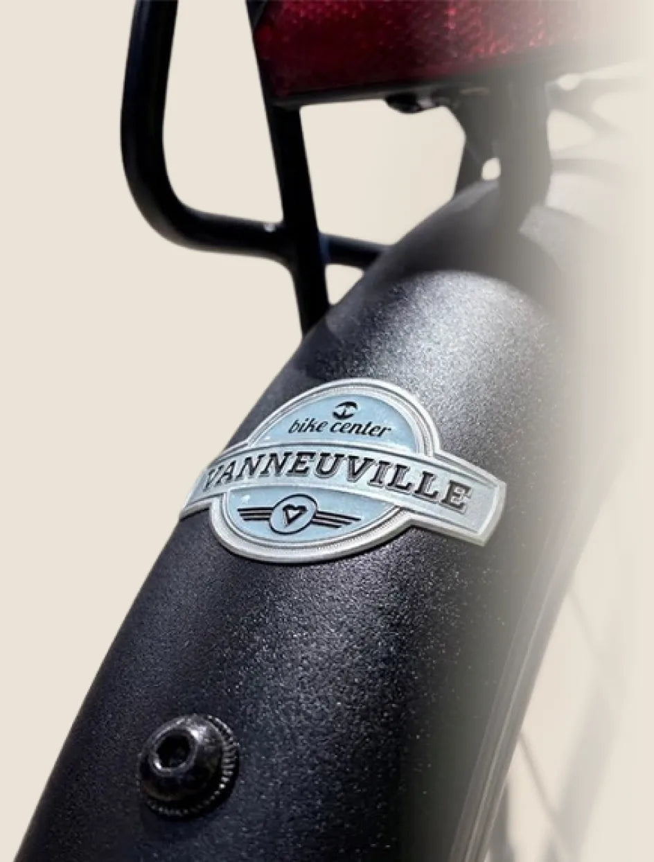 Bike shop metal label on a black bicycle mudguard