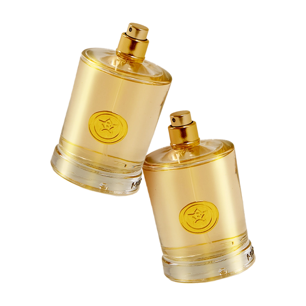 Round gold metal labels on two gold perfume bottles